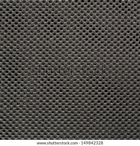 Dark gray fishnet cloth material fragment as a texture background
