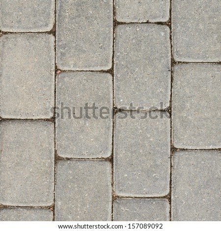 Tiled with paving stone bricks path\'s fragment as an abstract background