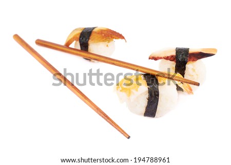 Nigiri sushi and chinese sticks composition isolated over the white background