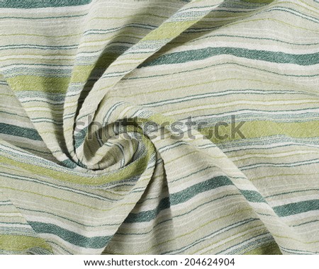 Fragment of a striped wrinkled green and white cloth fabric as a background texture