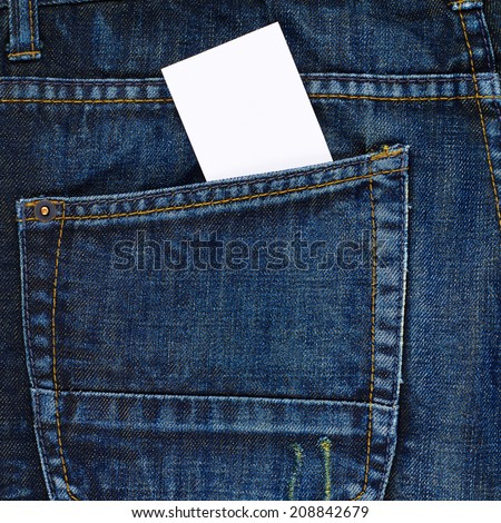 Copyspace white calling card in a back pocket of a navy blue denim jeans as a background composition