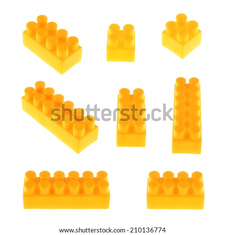 Set of plastic orange toy construction block bricks in multiple foreshortenings, isolated over the white background