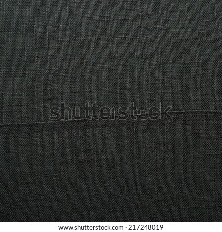 Black linen cloth material fragment as a background texture composition