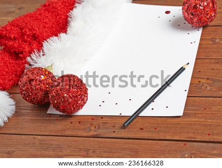 Letter to the Santa Claus composition of the copyspace blank sheet of paper next to multiple Christmas decorations over the wooden surface