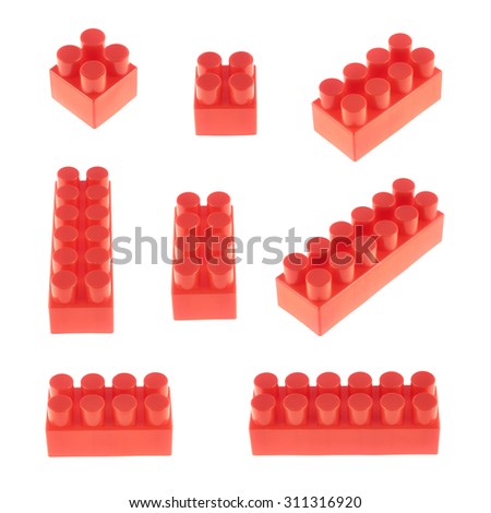Set of plastic red toy construction block bricks in multiple foreshortenings, isolated over the white background