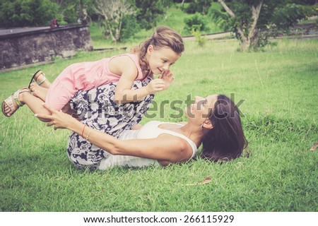 Happy mother and daughter playing in the park at the day time. Concept of celebration Mothers day .