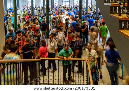 MADRID, SPAIN - JUNE 21 - People inside and outside the Apple store. New Apple Retail Store Opening in Sol square, in Madrid, Spain, on June 21, 2014