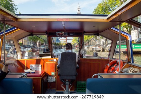 AMSTERDAM, NETHERLANDS - SEPTEMBER, 2014: Canal cruises are one of the  most popular attractions of Amsterdam.