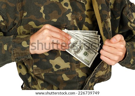 Man in military uniforms pulls money out of his jacket on a white background