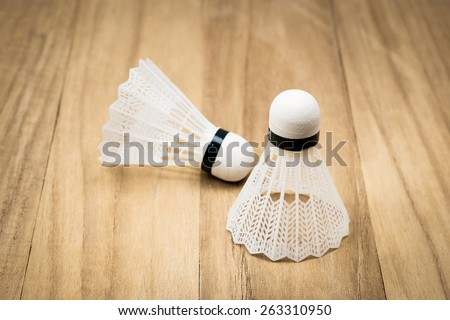 A badminton on wood background