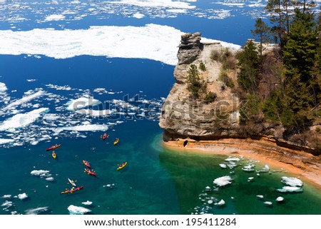 Kayaks maneuver through ice floes to view Miners Castle on Lake Superior. Late ice breakup created unusual ice formations at Pictured Rocks National Lakeshore in the Upper Peninsula of Michigan
