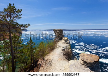 Lower overlook at Miners Castle on the shores of Lake Superior located at Pictured Rocks National Lakeshore. Ice floes appear on Lake Superior due to a spring breakup of ice.