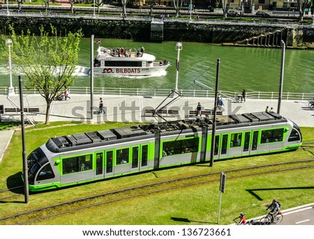 BILBAO, SPAIN - APRIL 13: Different means of transport in the city of Bilbao. It can be possible to use the tram, the boat, the car or the public bus, April 13, 2013 in BIlbao, Basque Country, Spain