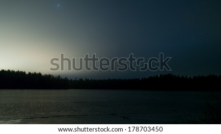 icy Swedish lake at night with stars