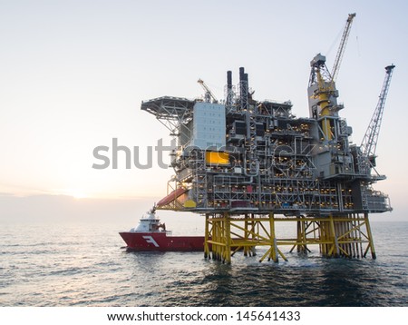 Offshore oil platform with a supply vessel on the North Sea, in the Norwegian sector