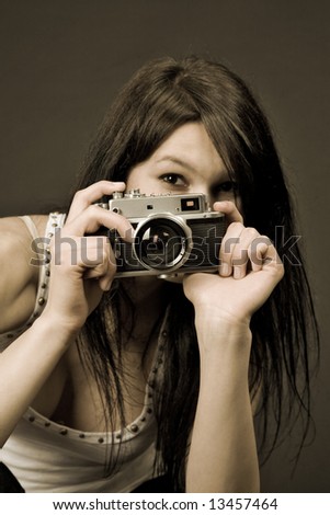Young girl with retro camera, sepia old style