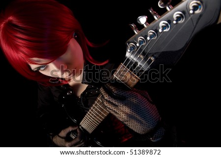 Redhead girl with guitar, selective focus on face, high angle view