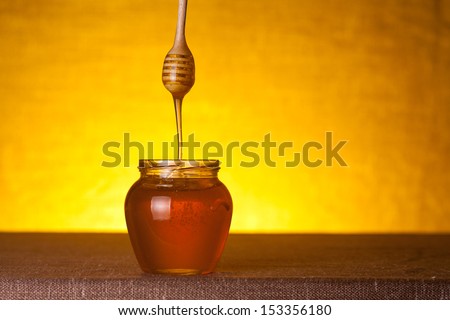 Honey jar and dipper, studio shot