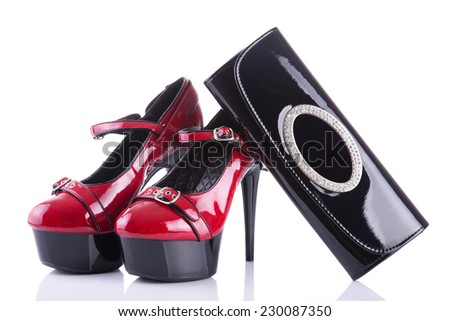 Glamorous red female shoes with black handbag clutch, isolated on white background with reflection