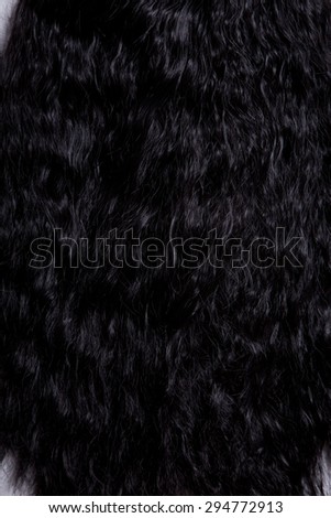 Texture of black healthy curly hair, soft focus