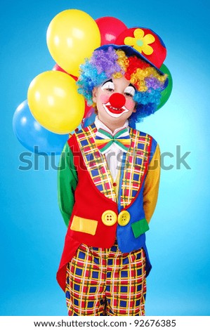 Child birthday clown with balloons over the blue background