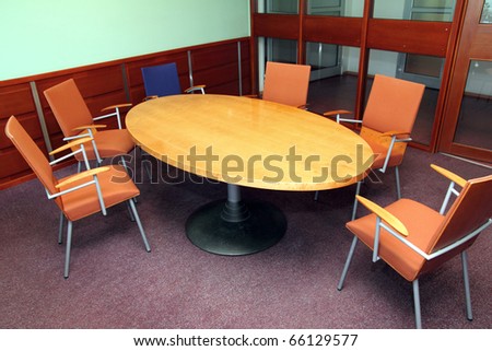 Round table talks with nobody chairs surround