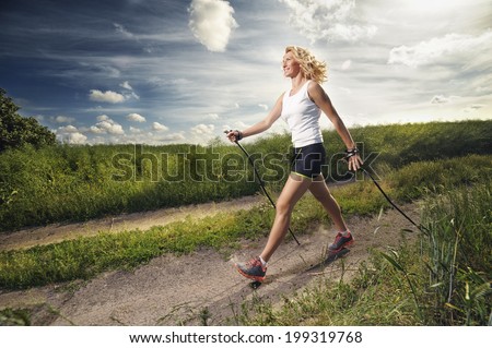 Similar – Foto Bild Person, die auf einer Landstraße zwischen Meer und Feld geht