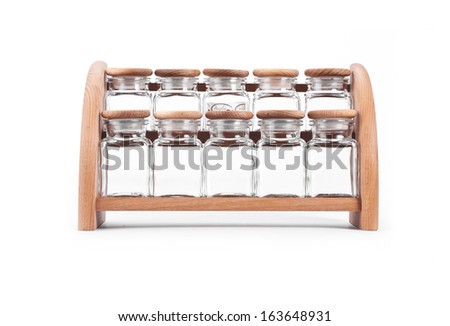 An  wooden spice rack isolated on white background. The bottles are empty.