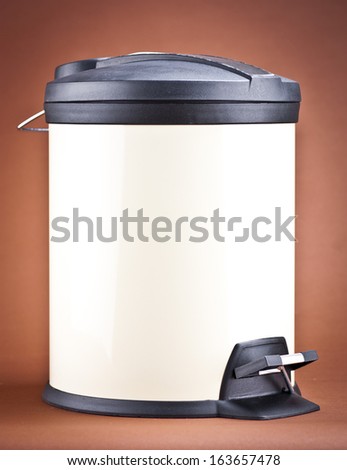 Modern refuse bin on a brown background