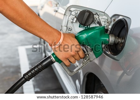 Man refilling the car with fuel on a filling station