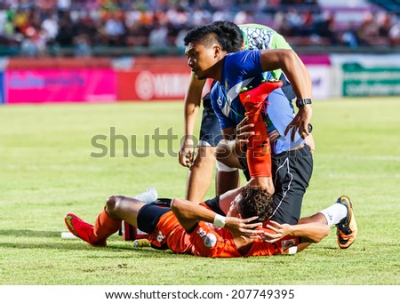 SISAKET THAILAND-JULY 23: First aid team of Sisaket FC. (blue) in action during Thai Premier League between Sisaket FC and Songkhla Utd at Sri Nakhon Lamduan Stadium on July 23,2014,Thailand