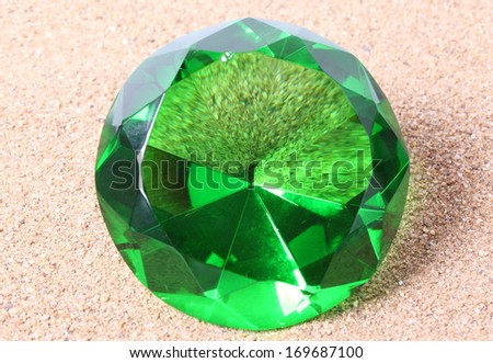green diamond on  sand background