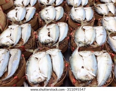 Mackerel steamed in bamboo bask.Thai gulf fish boiled cooking ready to eat pre sale in bamboo tray display for customer in tradition market thai people called this fish is platoo .select focus.