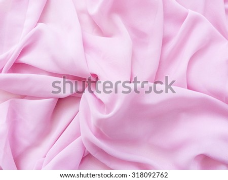 The texture of the silk fabric, soft pink. Beautiful soft crumpled pink silk texture