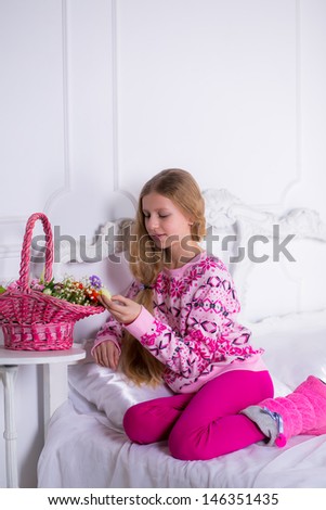 girl on the bed with a basket of flowers
