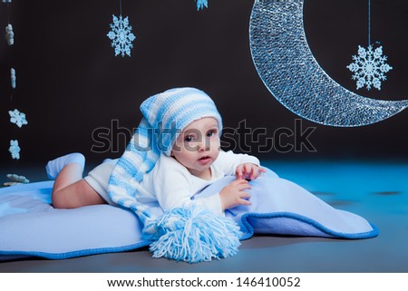 little boy in a long hat in the moonlight