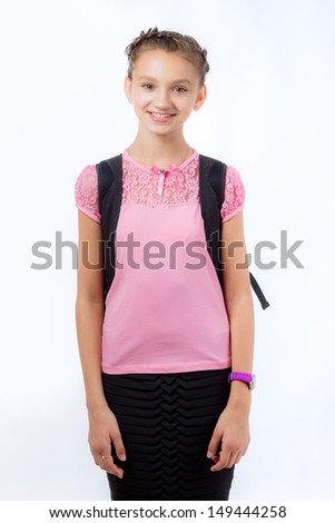 Young school girl ready for school. Little pupil is going to school. Happy young schoolgirl with satchel white background. Portrait of smiling, little girl in school uniform with backpack.