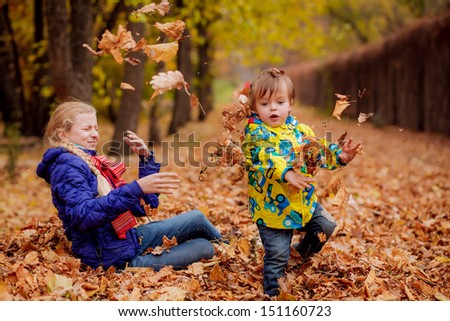 happy brother and sister playing in the autumn park