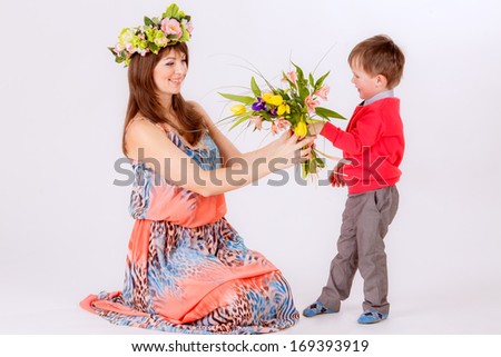 son gives mother flowers. hands holding a bouquet of tulips. Spring, March 8, International Women\'s Day.