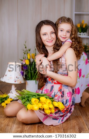 happy   mother and daughter of yellow tulips, March 8, International Women\'s Day