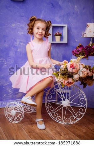beautiful stylish girl in a pink dress of spring scenery. flowers. Spring