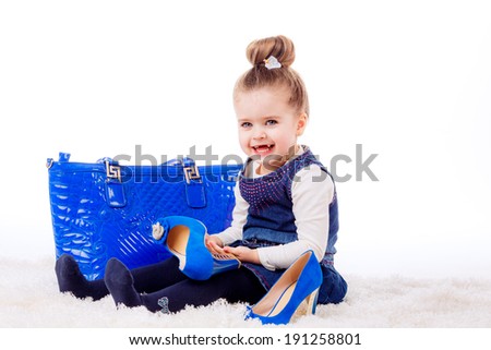 fashion portrait. Stylish little girl with shoes and bag mom. isolated on white background. fashionista, shopping