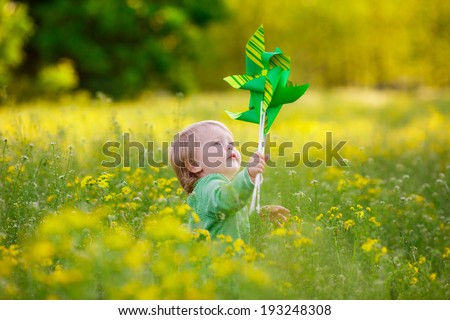 happy child in a field with yellow flowers