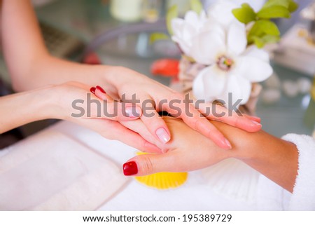 Beautiful girl in a beauty salon. manicure. spa treatments for hands. hand care.   Health