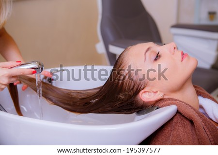 Beautiful girl in a beauty salon. wash your hair, hair care, health and beauty hair