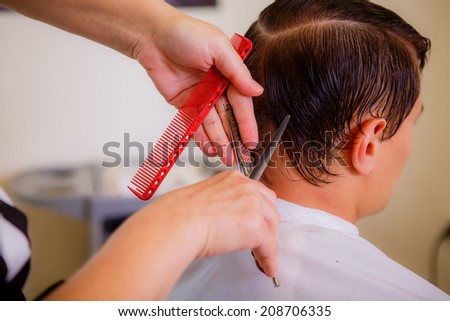 barber cuts a man in a beauty salon