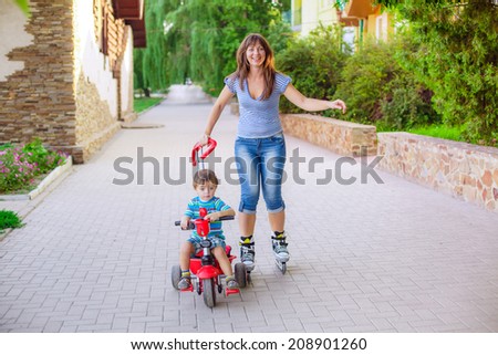 beautiful mom and son ride in the park