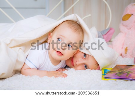 happy kids under a blanket. emotions