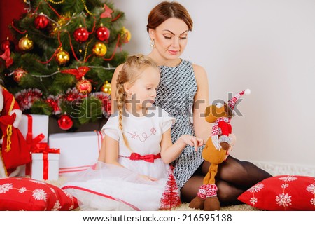 Christmas. happy mother and daughter in a room near the Christmas tree.