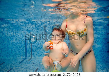 beautiful little girl swims underwater. child development, disease prevention